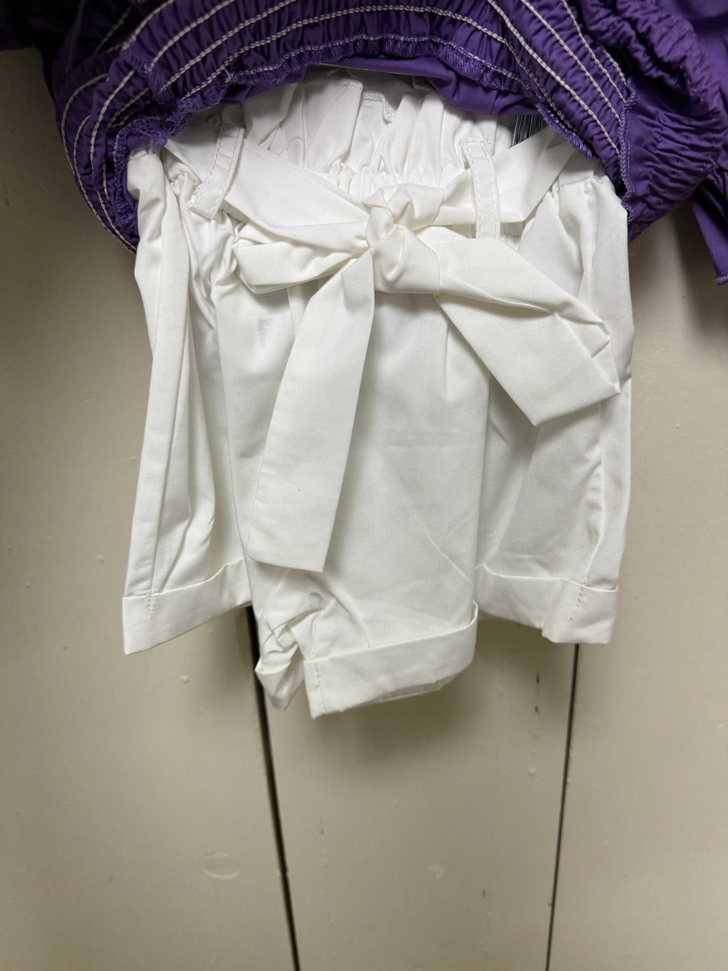 purple shirt w white shorts
